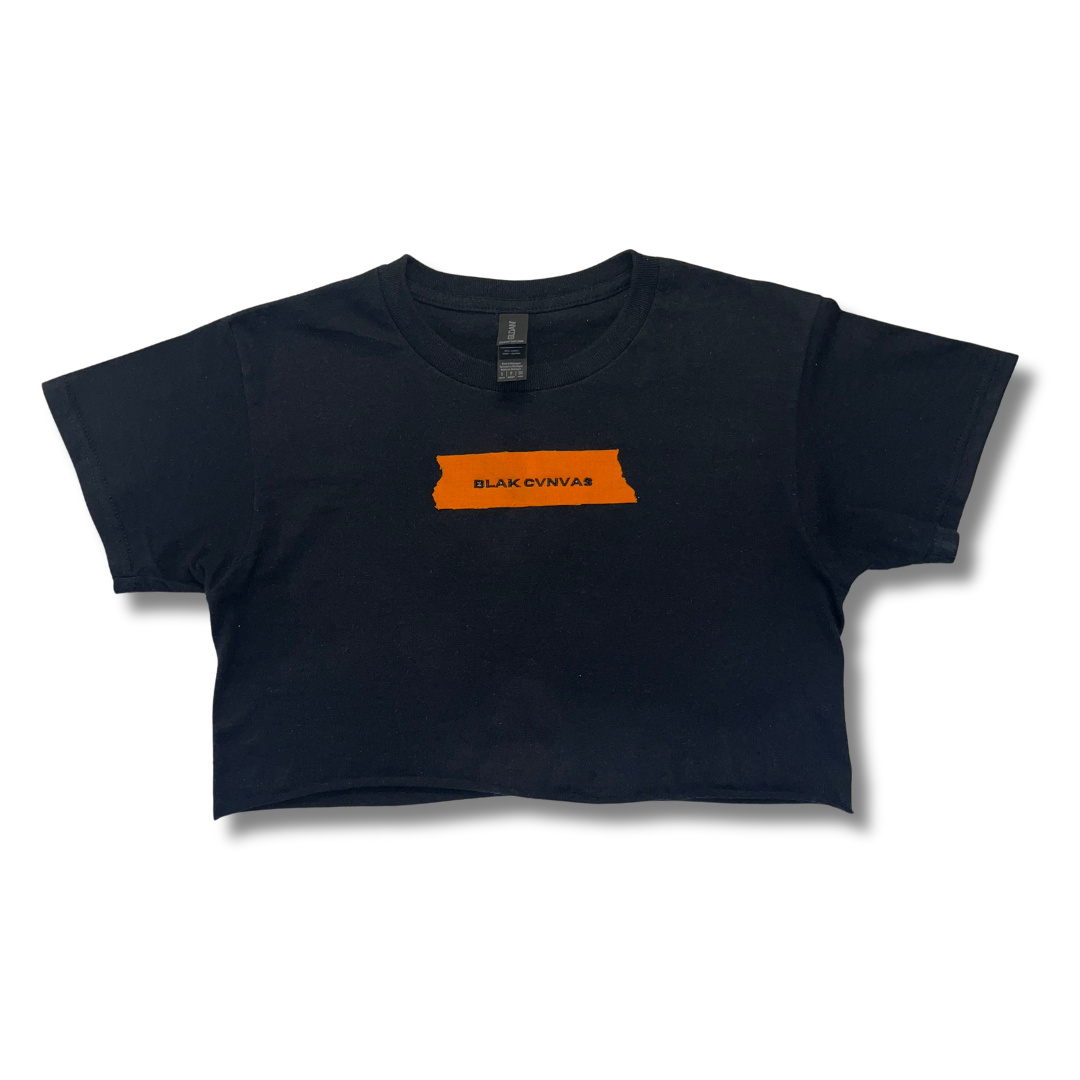 Cropped black tee with orange painter's tape logo by BLAK CVNVAS