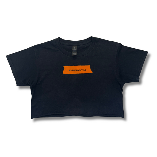 Cropped black tee with orange painter's tape logo by BLAK CVNVAS